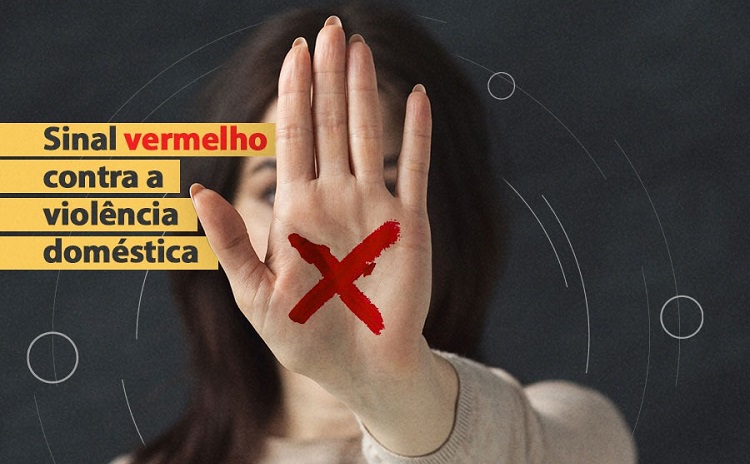 Mão espalmada com o sinal vermelho representando a campanha de combate à violência contra a mulher